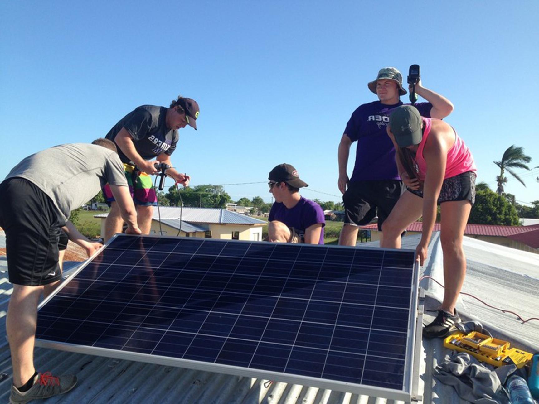 Students installing solar panels abroad